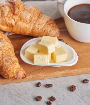 Delicious breakfast with fresh croissants and coffee served with butter